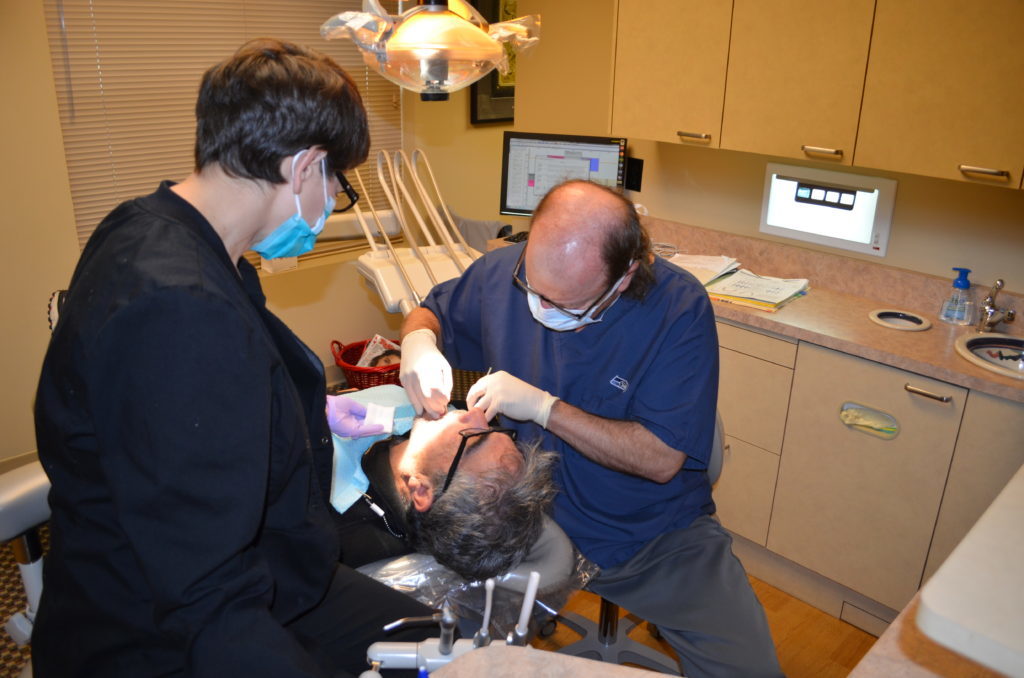 Dr. Hickey providing dental services to a patient in his Tacoma, WA office.