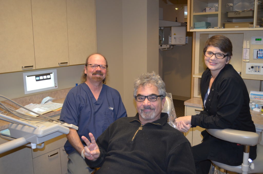 Dr. Hickey sits with a patient and Kirsten before starting an exam as part of the general dentistry menu options in his Tacoma WA office.