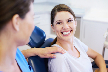 Woman smiling before her root canal because she has no anxiety about the procedure because of Dr. Hickey's skills.